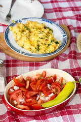 Served lunch with tomato salad and fried zucchini