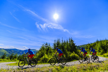 Fototapeta na wymiar Mountain biker riding on bike in summer mountains forest landscape. Man cycling MTB flow trail track. Outdoor sport activity. Multiple exposure