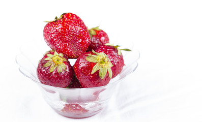 Strawberry in glass plate isolated on white