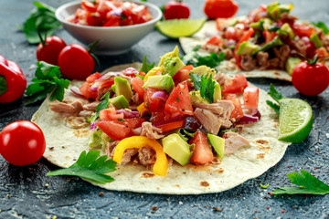 Tuna Tortilla with avocado, fresh salsa, limes, greens, parsley, tomatoes, red yellow pepper. colorful vegetable. Healthy Food