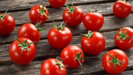 Fresh cherry ripe red tomatoes from home garden on rustic wooden table. selected focus