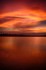 Naklejka premium view from water of the sunrise full of colors