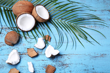 Coconuts with leafs on blue wooden table