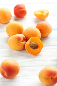 Ripe apricots fruit on white wooden table
