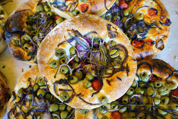 Round focaccia bread topped with vegetables