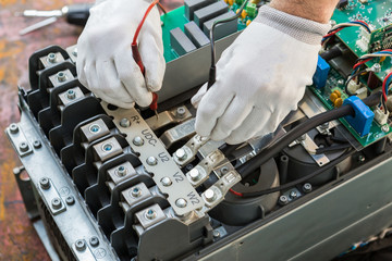 engineer working on checking and maintenance  inverter and string monitor unit 