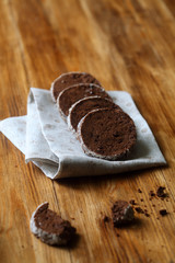 Chocolate Sable - Shortbread Cookies, on grey napkin, on wooden table.