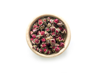 Exotic tea, roses buds in rustic bowl, topview