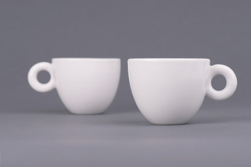 Two white coffee cup on grey background. Design template for Mock Up