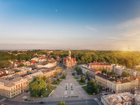 Drone aerial view of Krakow old town, main square and church at sunset time