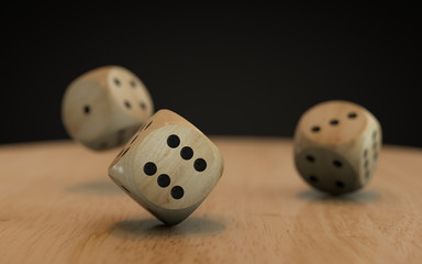 Rolling down three dice on a wooden desk with a black background