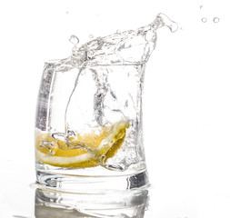Lemon slice falls in a glass of water - Splash