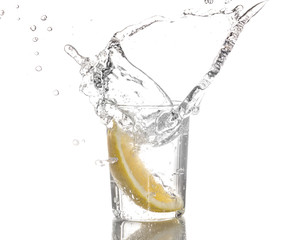Lemon slice falls in a glass of water - Splash