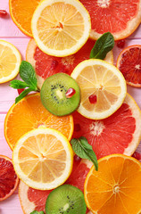 Fototapeta na wymiar Citrus slices on color wooden background