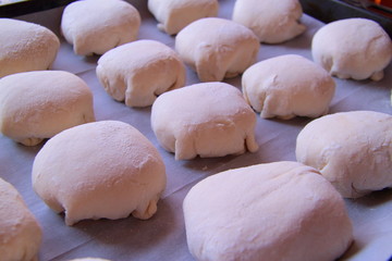 sweet cakes on the baking sheet, the dough on a baking sheet, the dough used to make fresh, homemade delicious muffins