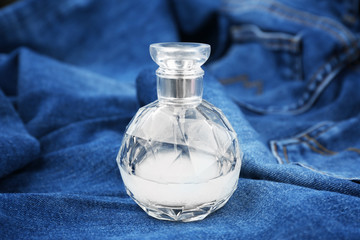 Perfume bottle on denim cloth