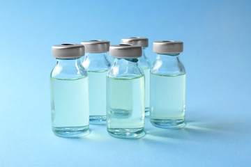 Medical ampules on colour background. Vaccination concept