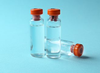 Medical ampules on colour background. Vaccination concept