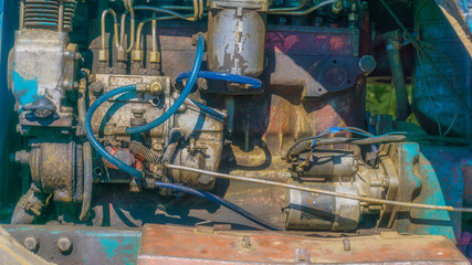 A rusty, old engine and compressor for background.
