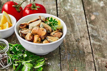 Mussels with lemon, tomato and herbs. Shellfish seafood. Delicious snack for gourmands