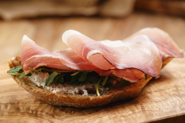 italian sandwich with speck and arugula salad