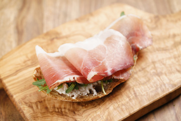 italian sandwich with speck and arugula salad