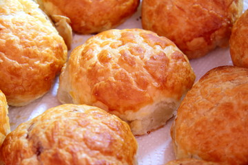 Baked sweet buns on a baking sheet with a ruddy crust, homemade delicious cakes
