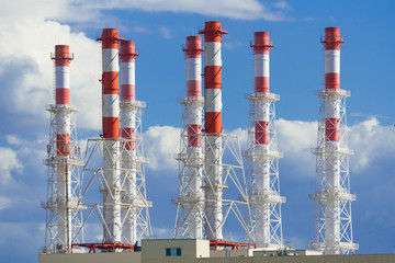 Industrial chimneys on a background of blue sky