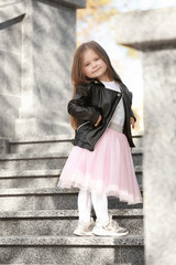 Little fashionable girl outdoors on spring day