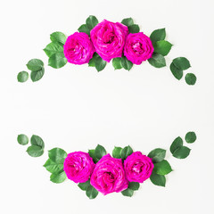 Wreath frame with roses, pink flower and leaves on white background. Flat lay, top view