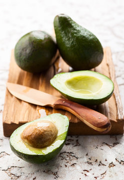Fresh avocado on wooden board