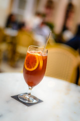 ice lemon tea in a atall glass with three lemon slices