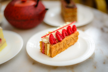 Vanilla and Raspberry Mille feuille pastry cake on white china plate