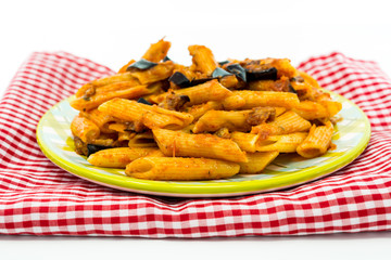 Pasta with aubergine and tomato on a the table