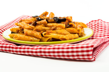 Pasta with aubergine and tomato on a the table