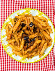 Pasta with aubergine and tomato on a the table