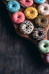 Glazed American donuts on wooden background with blank space