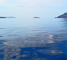 Fototapeta na wymiar hill and rocks on the summertime beach in europe greece santorini island