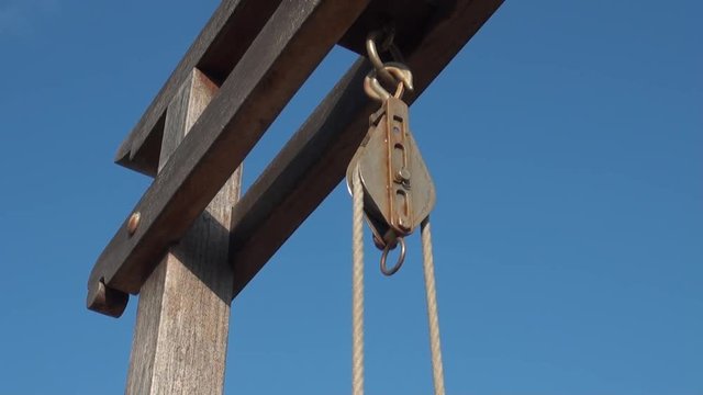 Pulley located at the top of a water well with a rope to draw water. The water pit is located in Penghu, Taiwan.