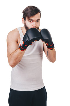 unshaved man in white t-shirt with tattoo in boxing gloves