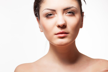 Obraz premium Beautiful brunette posing on white background. Wet hairs. Studio posing