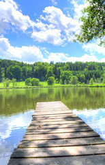 Wooden dock with a view of Waldweiher lake, Dietramszell, Bavaria, Germany