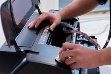 Repairman repairing broken color printer