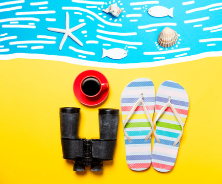 Summertime flip-flops and coffee cup with binocular