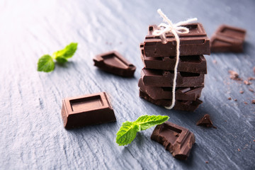 Tied chocolate pieces with mint on table