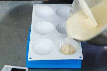 Woman in white uniform prepares food