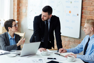 Businessmen listening to explanation of his colleague