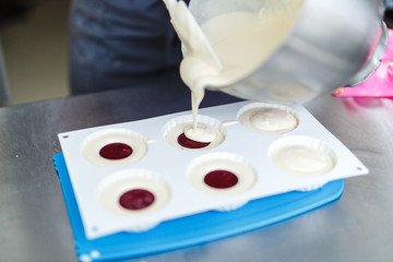 Woman in white uniform prepares food