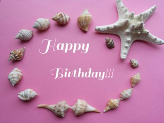 Greeting card Happy birthday decorated with seashells on pink background