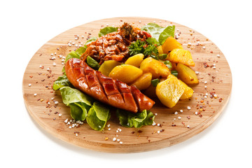 Grilled sausages served on cutting board 